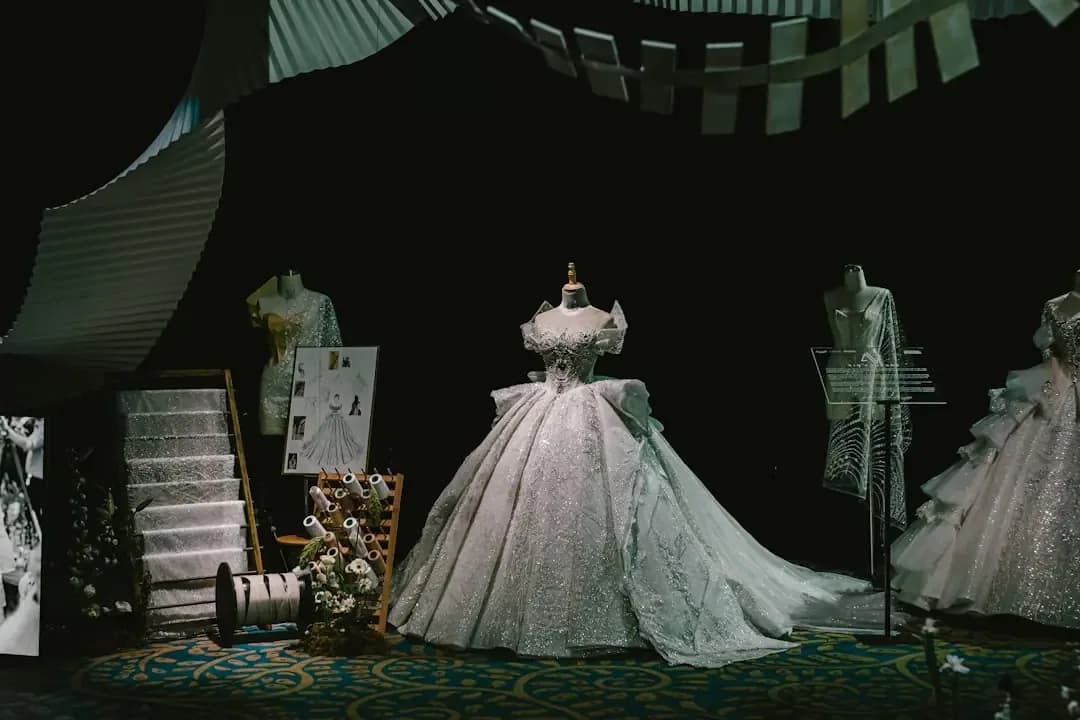 a display of wedding gowns in a dark room