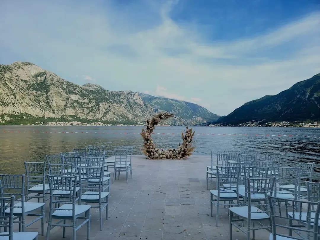 a bunch of chairs that are by a body of water