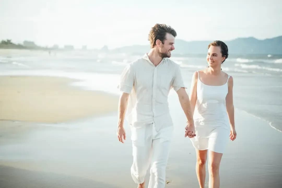 Couple walking hand in hand on a beach