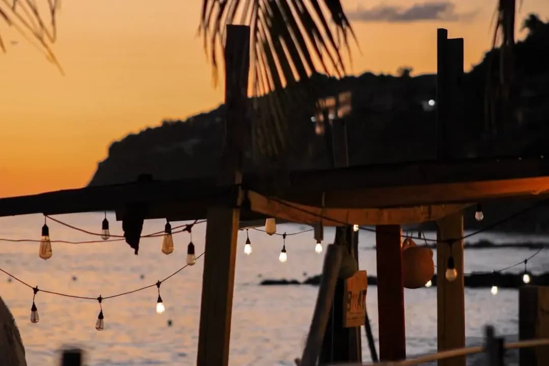 Beachside cafe with string lights at sunset