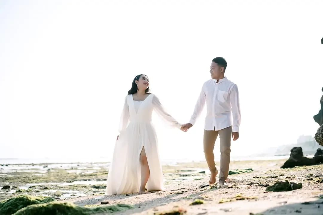 a man and woman holding hands