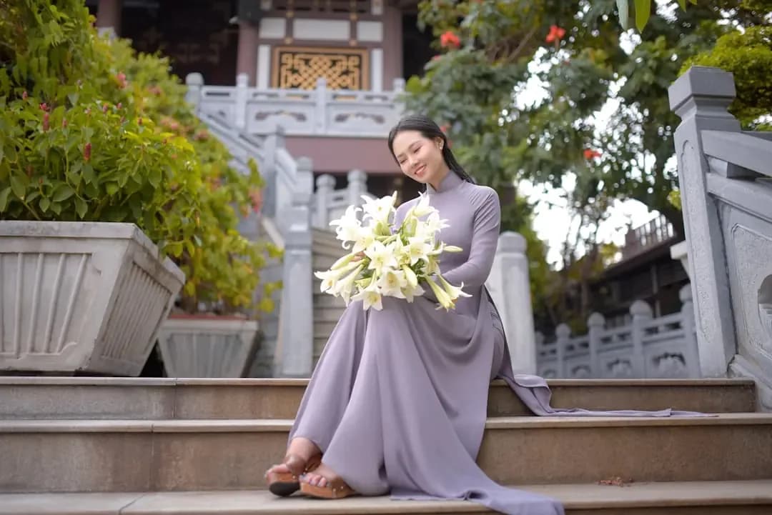 woman in white long sleeve dress holding bouquet of flowers