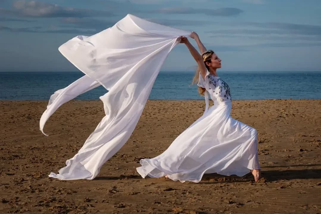 A woman in a white dress on a beach