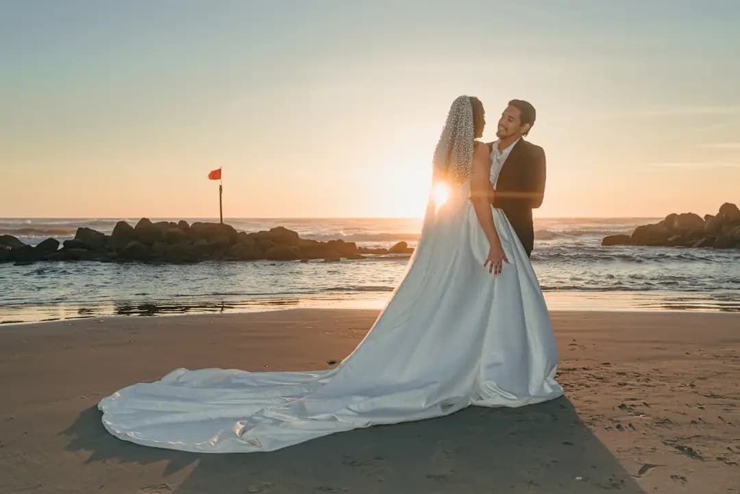 Bride and groom on beach at sunset