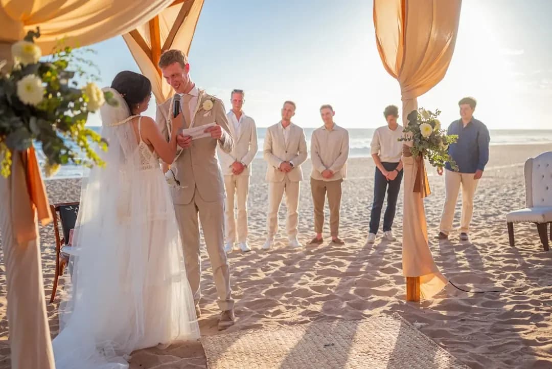 Wedding ceremony on a sandy beach at sunset.
