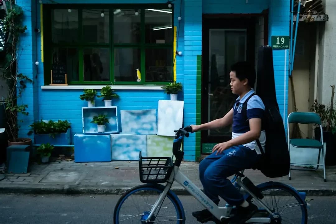 man in blue t-shirt riding on bicycle during daytime