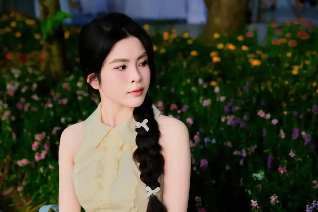 Young woman with braid in floral garden